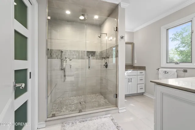 a bathroom with a shower sink and mirror