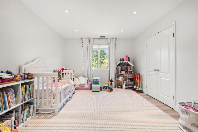 a bedroom with furniture and a book shelf