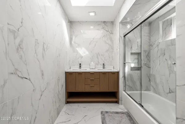 a bathroom with a bathtub and a sink