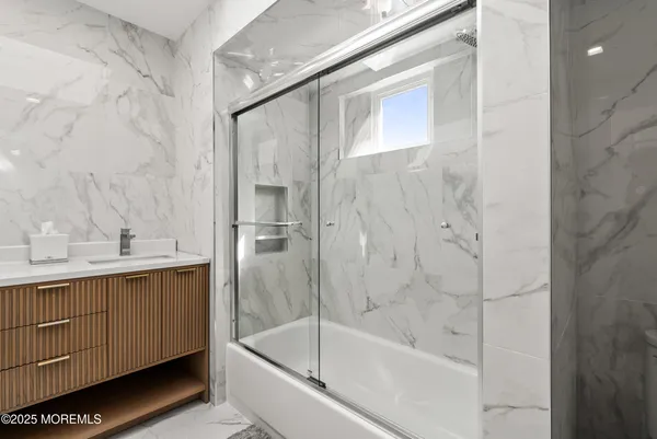 a bathroom with a bathtub and a sink