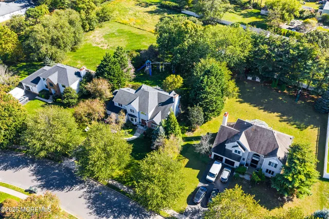 an aerial view of a house with yard swimming pool and outdoor seating