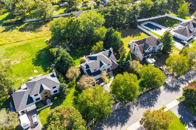 an aerial view of a house with a yard and garden