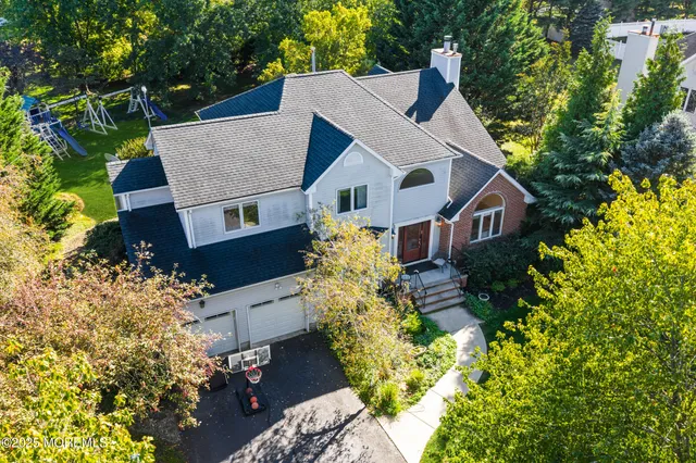 a aerial view of a house with a yard and garden