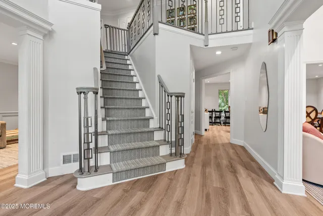 a view of entryway with wooden floor and stairs