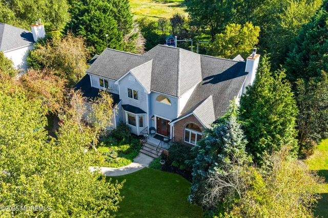 an aerial view of a house with a yard basket ball court and outdoor seating