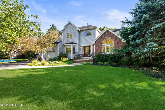 a front view of house with yard and green space