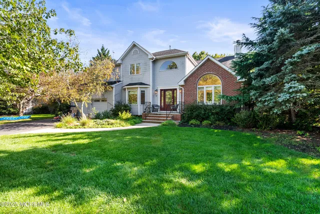 a front view of a house with a garden and plants