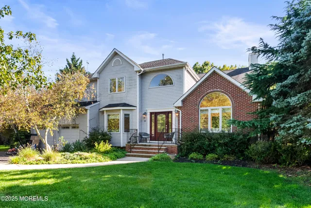 a front view of a house with a garden and plants