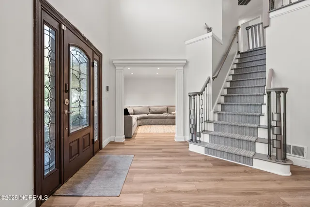 a view of a hallway view with wooden floor and staircase