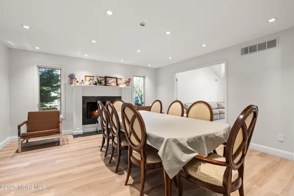 a view of a a dining room with furniture and wooden floor