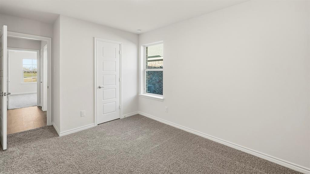 403 Flintlock Road Caddo Mills, TX 75135 - Photo 12 of 26 Unfurnished bedroom with carpet and a closet