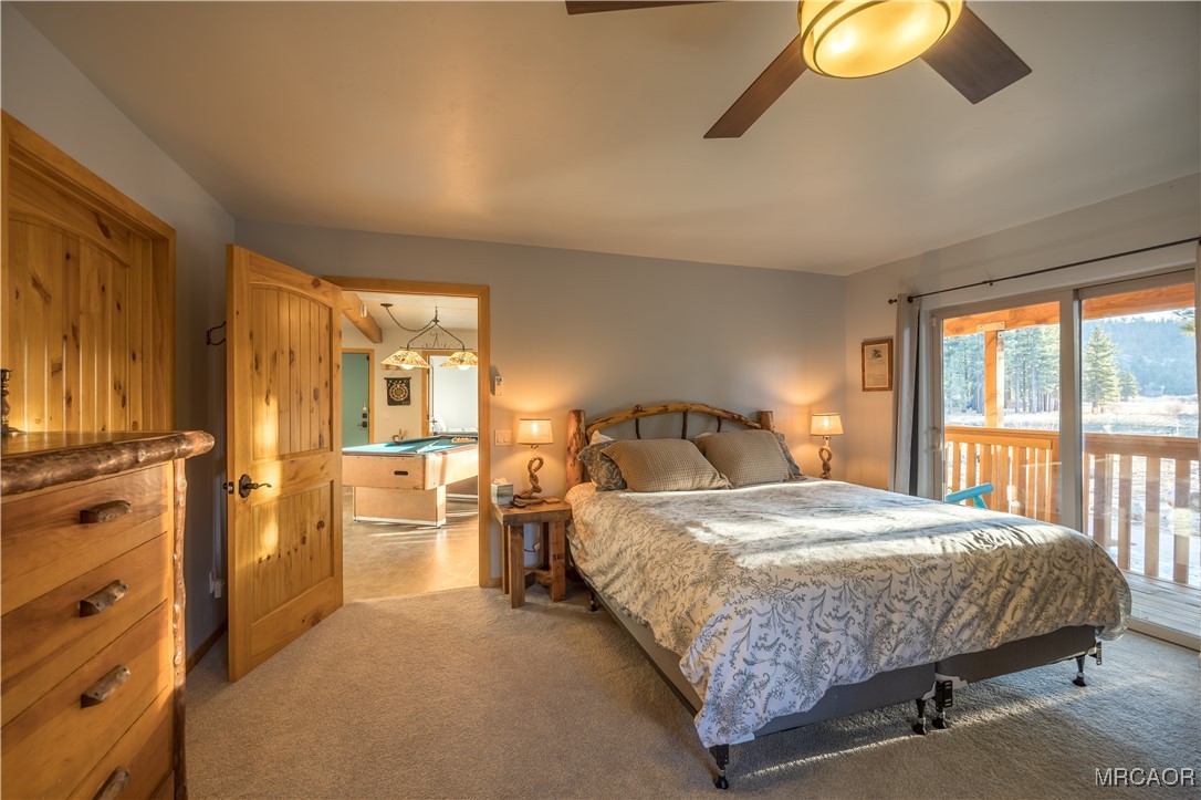 448 Edgemoor Road Big Bear Lake, CA 92315 - Photo 16 of 42 a bedroom with a bed and a chandelier
