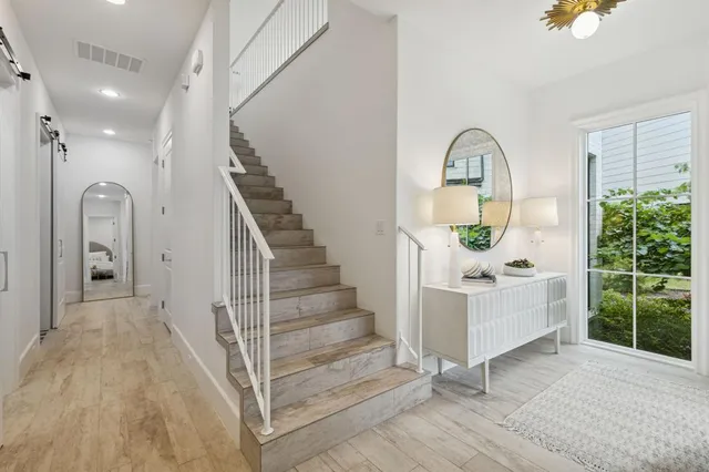 a view of entryway and hall with wooden floor