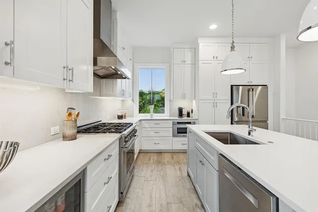 a bedroom with a bed and a lamp on dresser