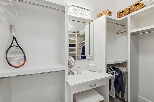 a bathroom with double vanity sink two mirror and a shower