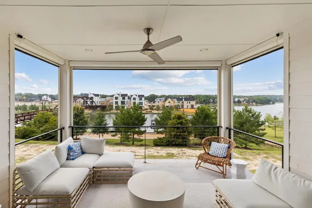 a living room with patio furniture and a floor to ceiling window