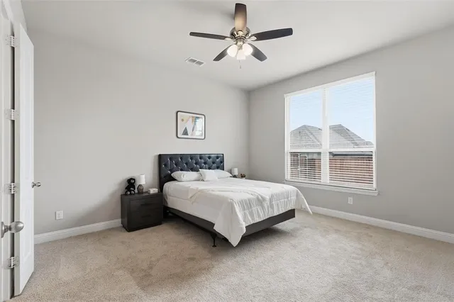 a bedroom with a bed next to a window