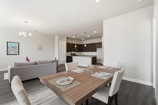 a living room with furniture and kitchen view