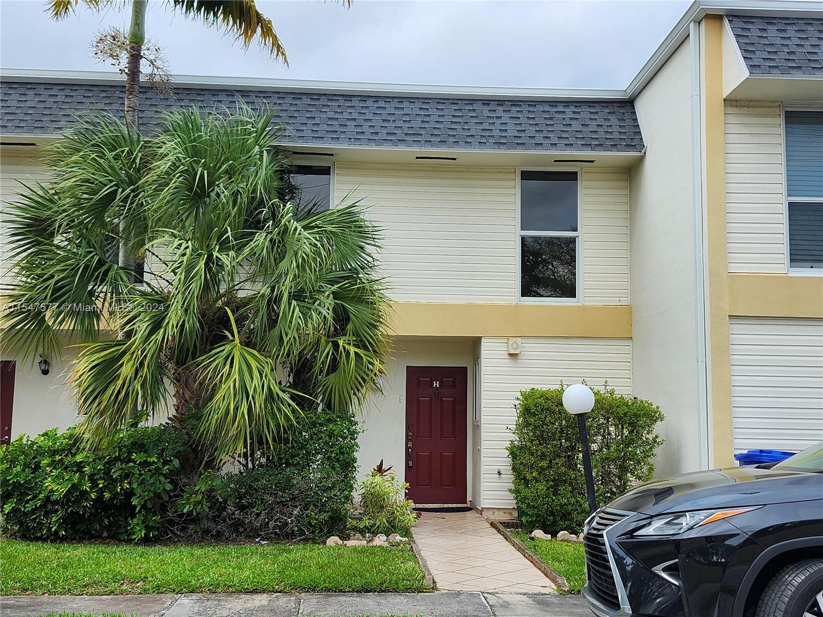 3321 Raleigh Street, Unit 3H Hollywood, FL 33021 - Photo 1 of 38 a front view of a house with garden