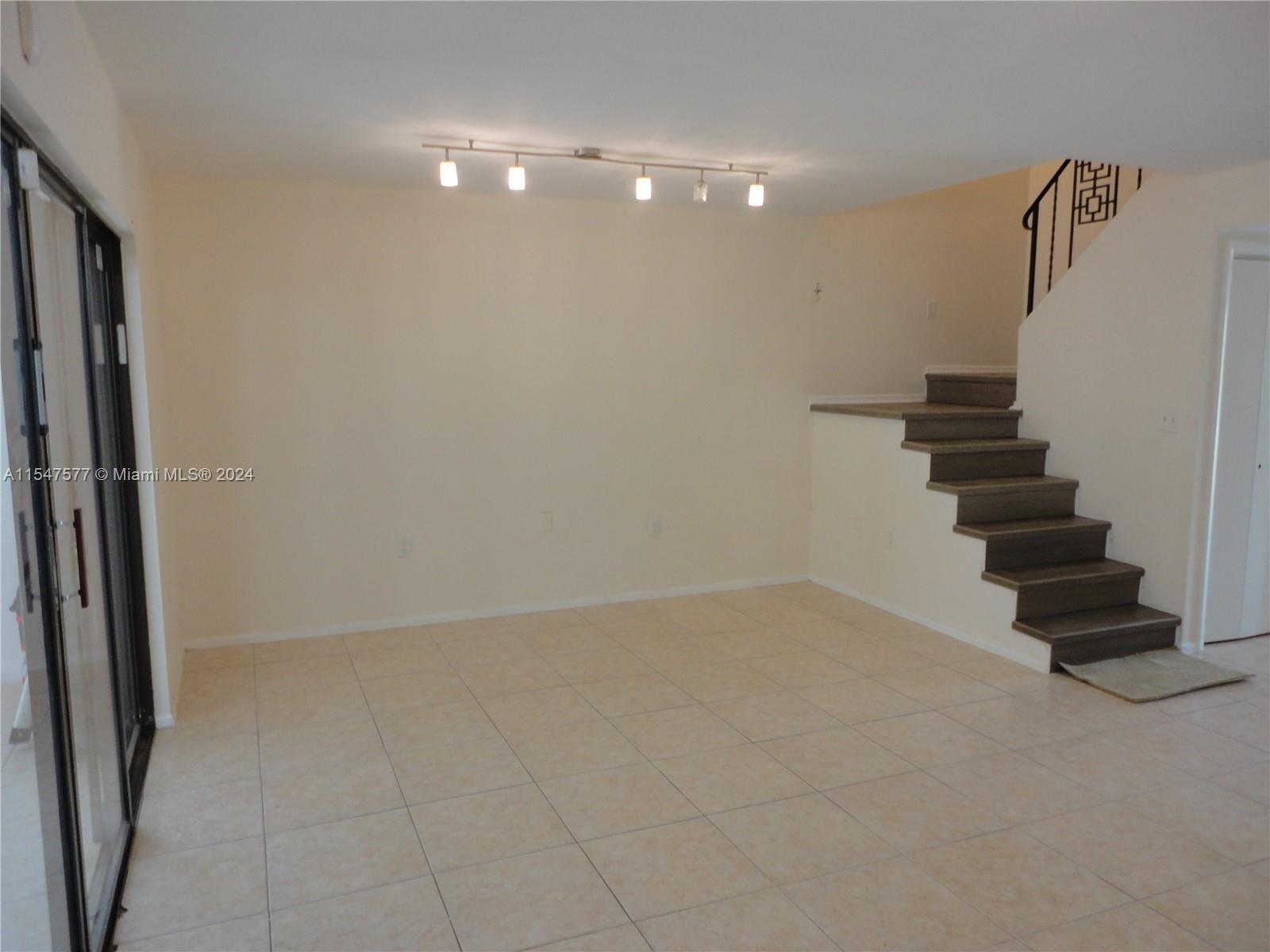 3321 Raleigh Street, Unit 3H Hollywood, FL 33021 - Photo 13 of 38 a view of an empty room with stairs