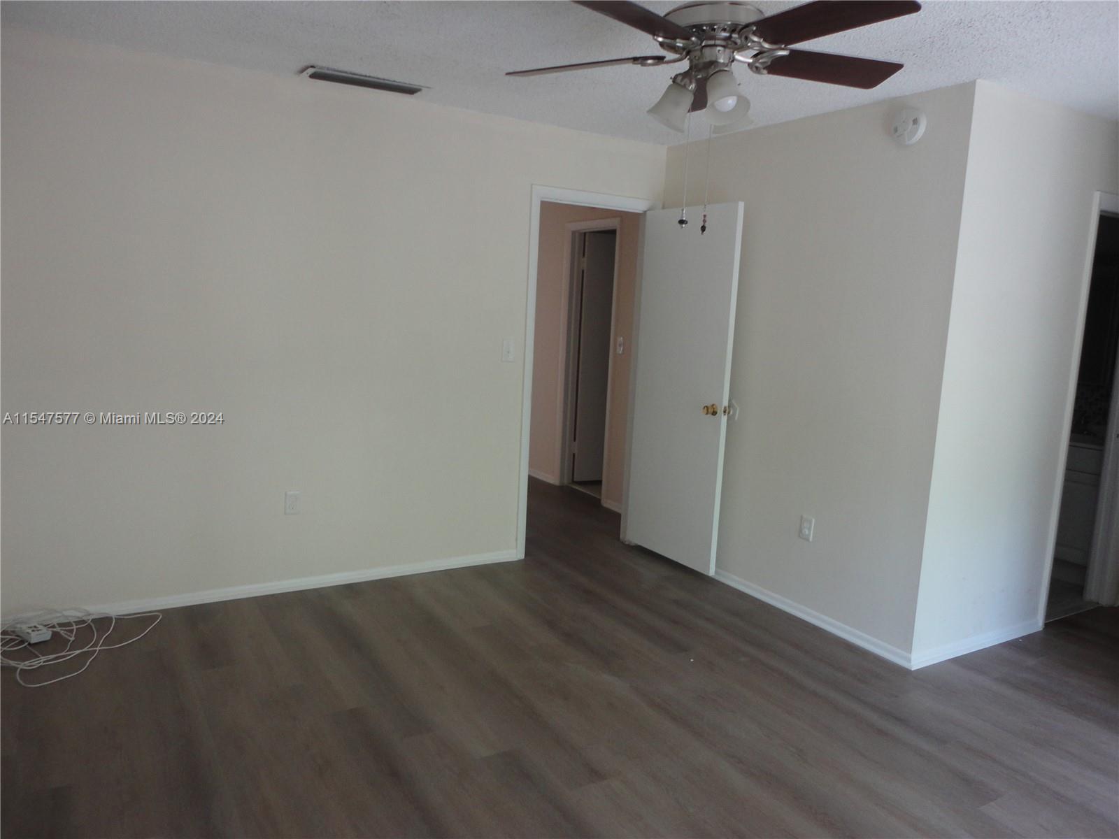 3321 Raleigh Street, Unit 3H Hollywood, FL 33021 - Photo 19 of 38 a view of an empty room with wooden floor