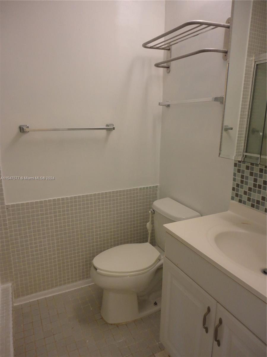 3321 Raleigh Street, Unit 3H Hollywood, FL 33021 - Photo 23 of 38 a white toilet sitting next to a bathroom sink
