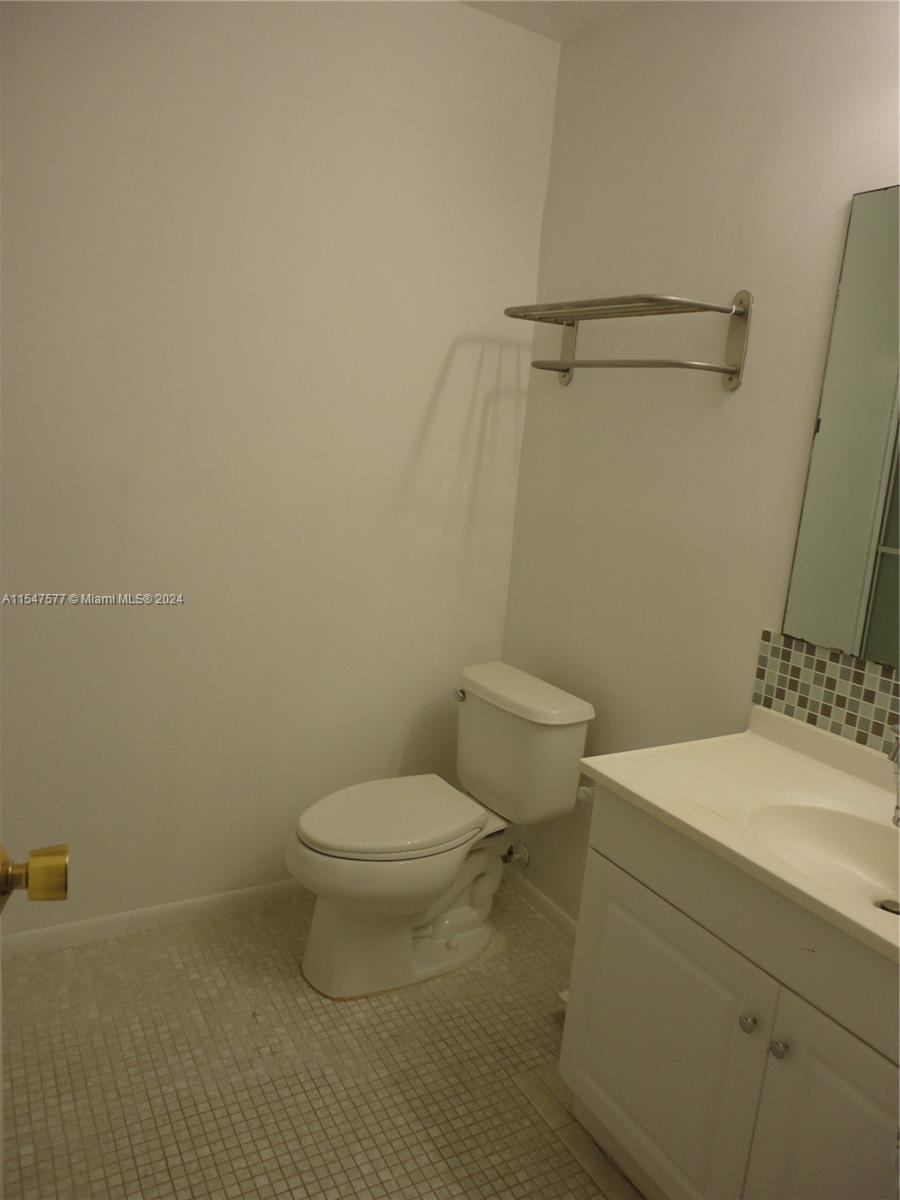3321 Raleigh Street, Unit 3H Hollywood, FL 33021 - Photo 25 of 38 a white toilet sitting next to a bathroom sink