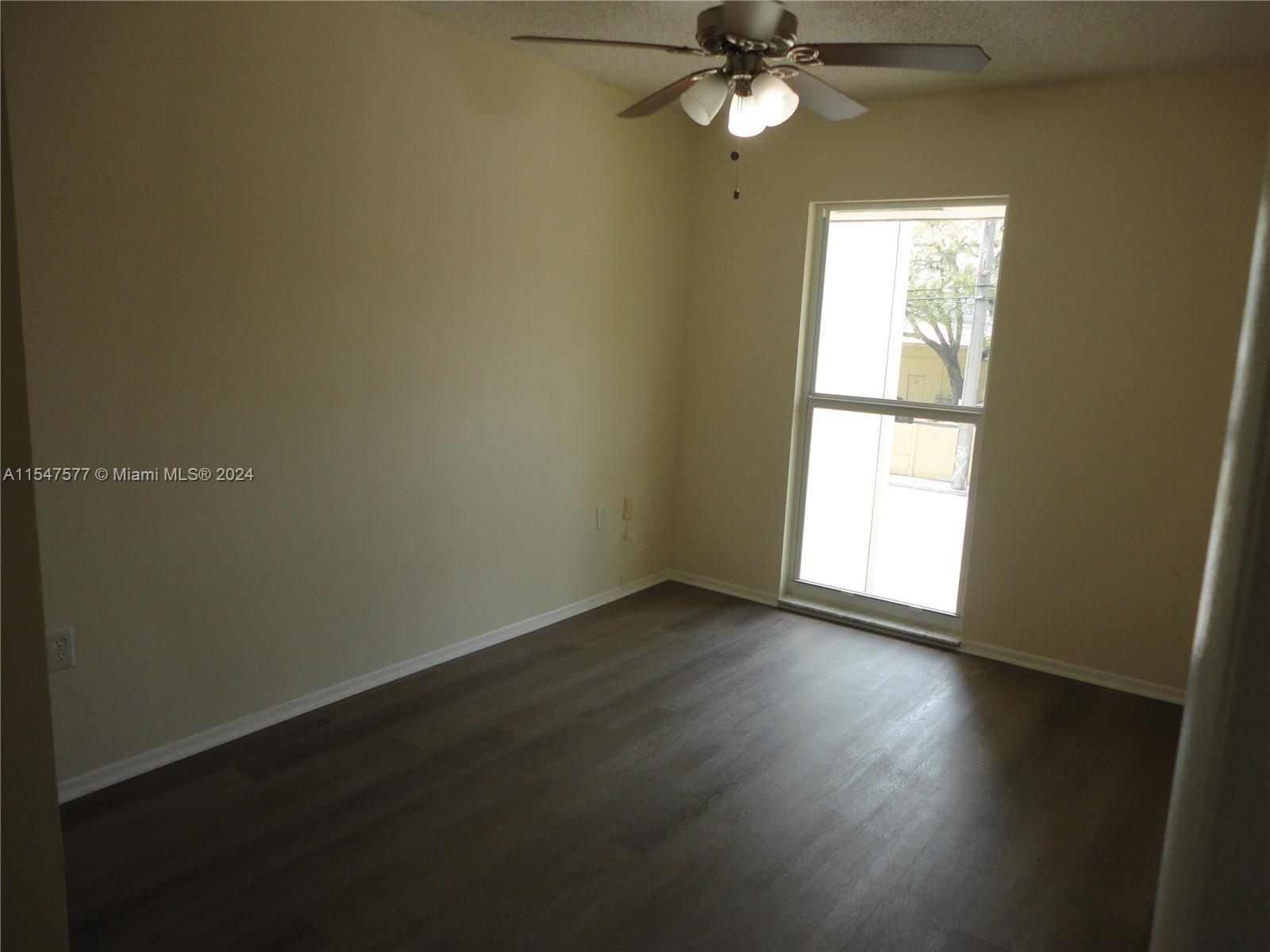3321 Raleigh Street, Unit 3H Hollywood, FL 33021 - Photo 27 of 38 a view of an empty room with wooden floor and a window