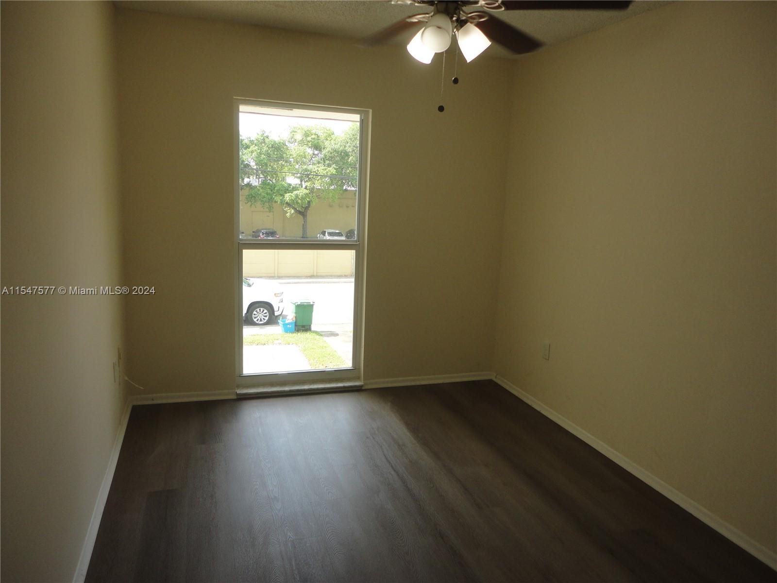 3321 Raleigh Street, Unit 3H Hollywood, FL 33021 - Photo 28 of 38 an empty room with wooden floor and windows