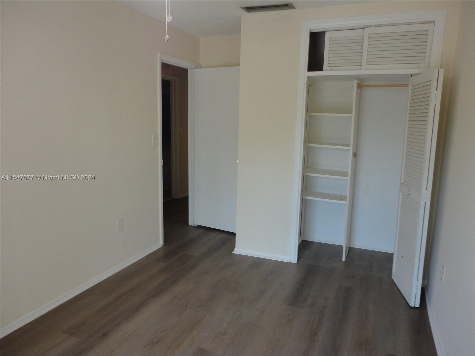 3321 Raleigh Street, Unit 3H Hollywood, FL 33021 - Photo 29 of 38 an empty room with wooden floor and closet