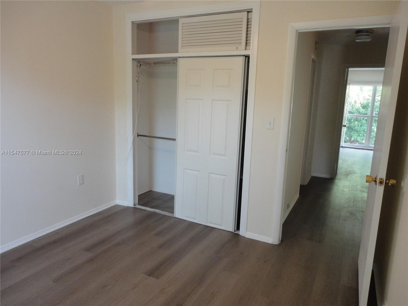3321 Raleigh Street, Unit 3H Hollywood, FL 33021 - Photo 31 of 38 an empty room with wooden floor and closet
