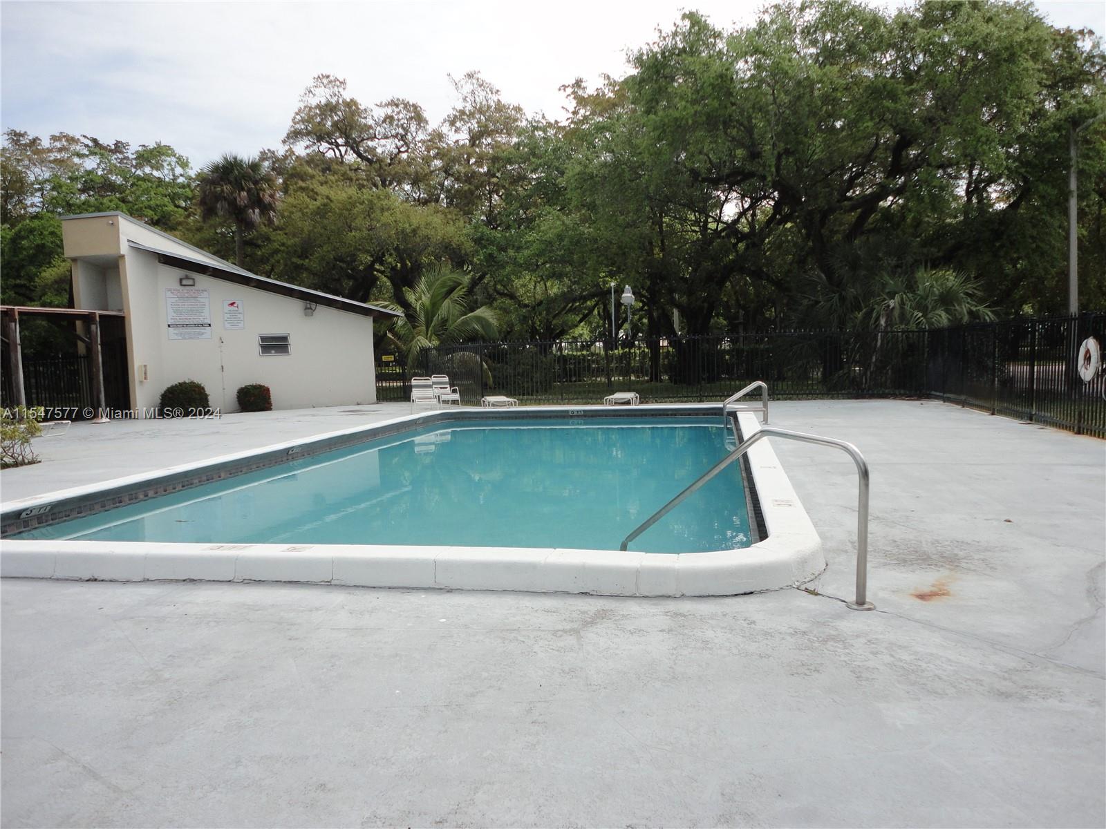 3321 Raleigh Street, Unit 3H Hollywood, FL 33021 - Photo 34 of 38 a view of a white house with a yard and sitting area