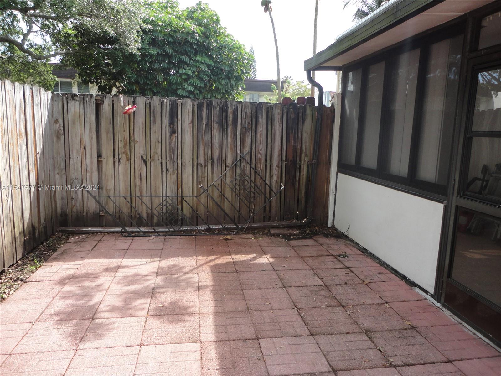 3321 Raleigh Street, Unit 3H Hollywood, FL 33021 - Photo 36 of 38 a view of a backyard with wooden fence