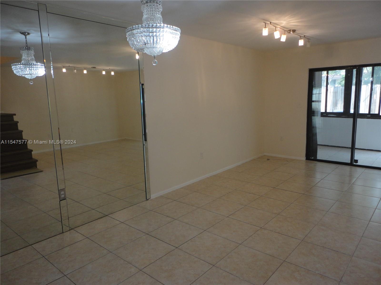3321 Raleigh Street, Unit 3H Hollywood, FL 33021 - Photo 10 of 38 a view of a room with an empty space and a chandelier