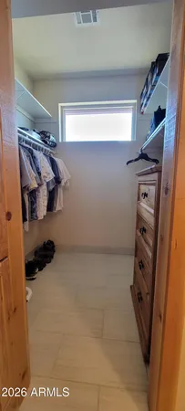 a bedroom with a bed and a night stand