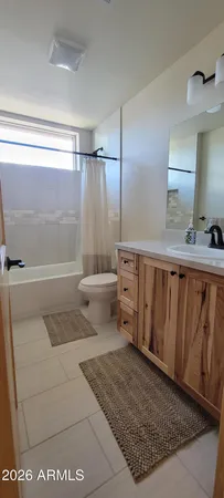 a white toilet sitting next to a bathroom sink