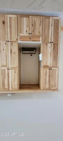 a living room with stainless steel appliances granite countertop a couch and a stove top oven