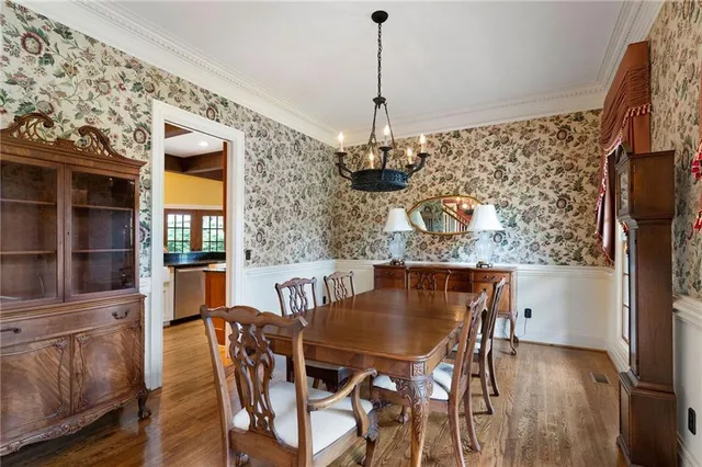 a view of a dining room with furniture wooden floor and chandelier