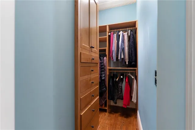 a dining room with furniture a chandelier and wooden floor