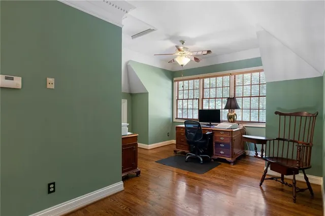 a living room with furniture a flat screen tv and large window