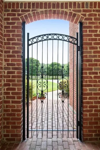 a view of a tennis court with a view of house