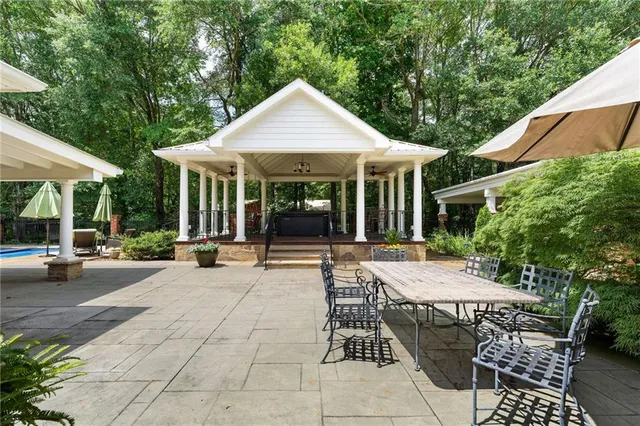 a front view of a house with swimming pool and sitting area