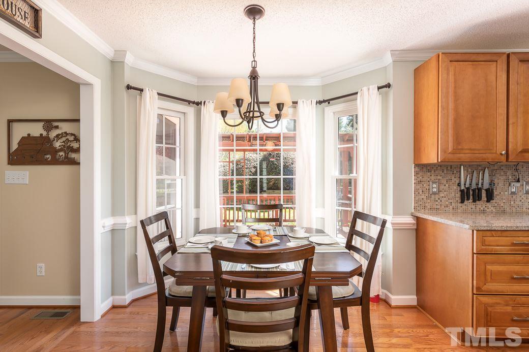 3220 Sandy Bluff Road Raleigh, NC 27616 - Photo 14 of 23 a view of a dining room with furniture window and wooden floor