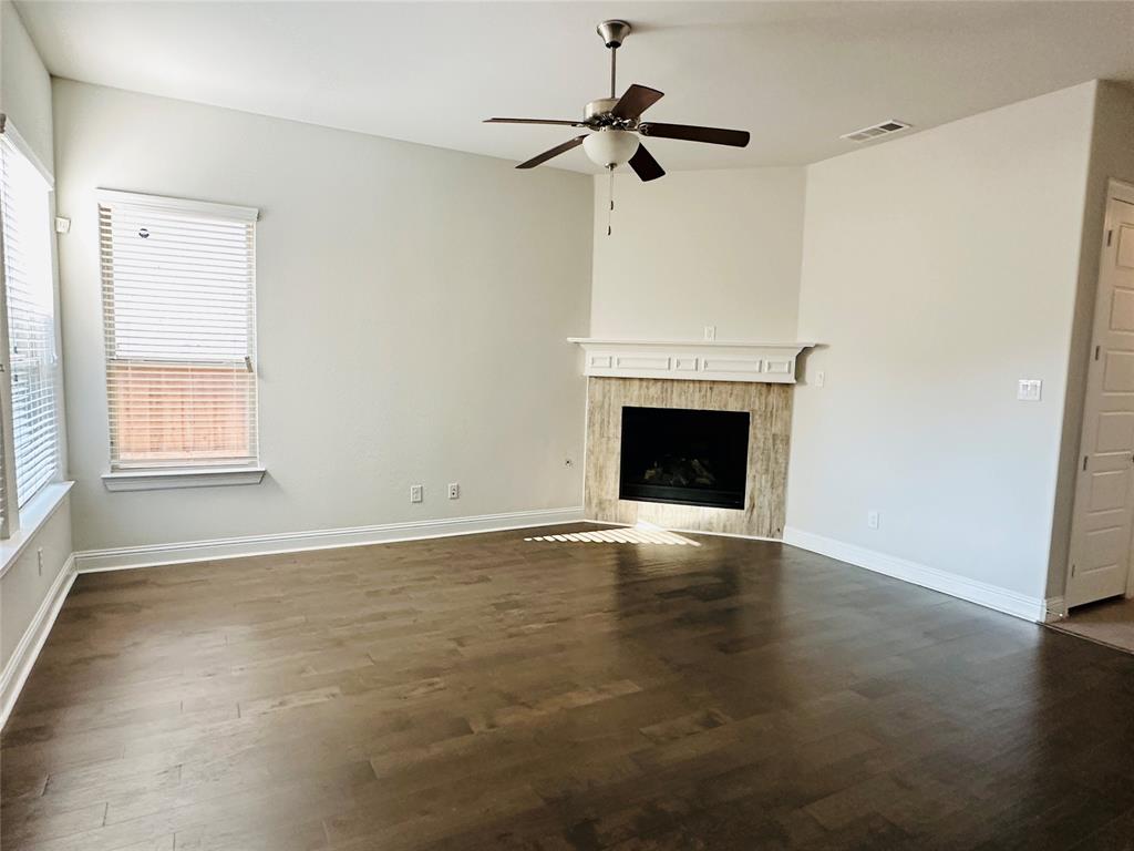 806 Davids Way Allen, TX 75013 - Photo 4 of 24 a view of an empty room with a fireplace and a window