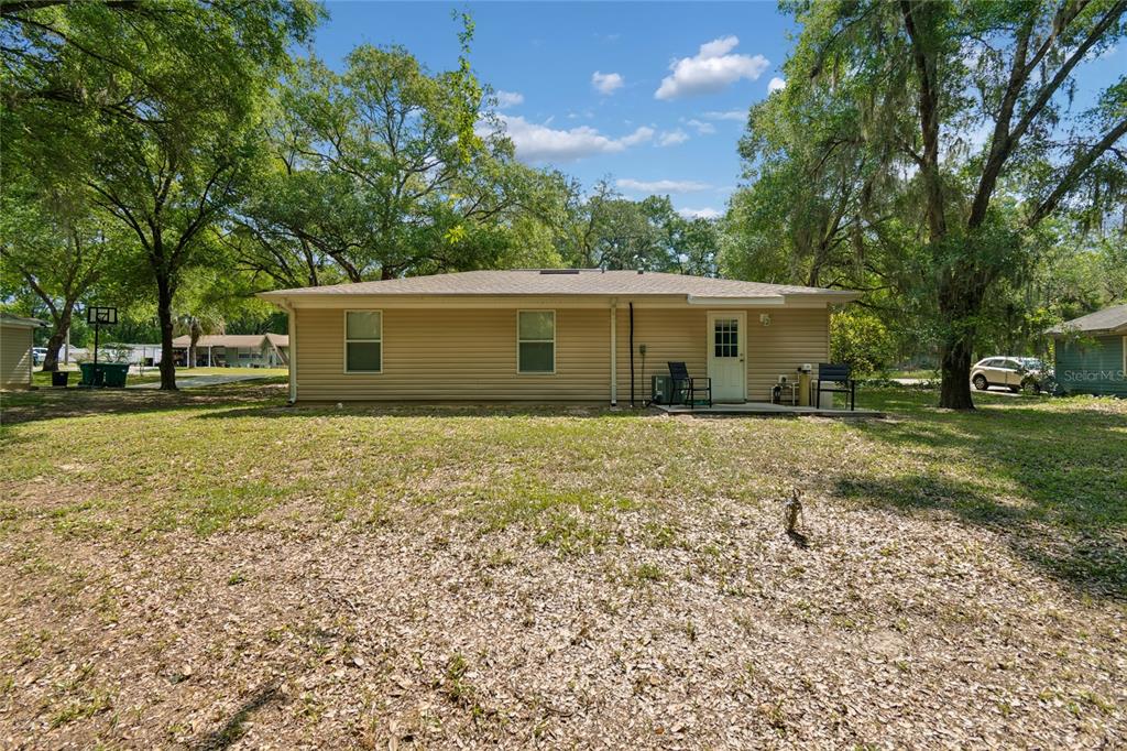 468 North Wheeler Avenue Inverness, FL 34453 - Photo 22 of 24 a house with trees in front of it