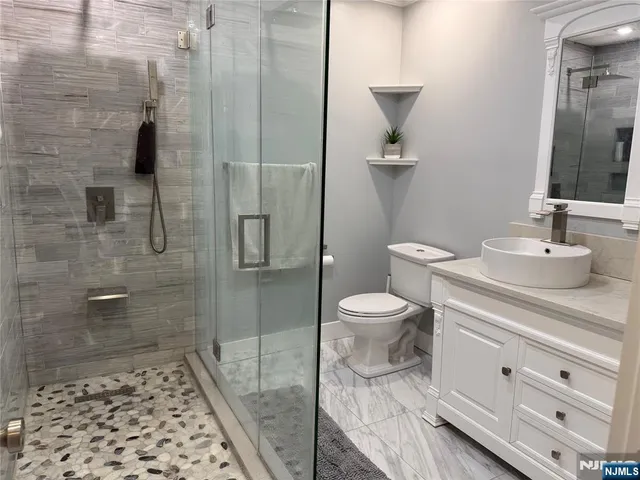 a bathroom with a toilet sink and shower