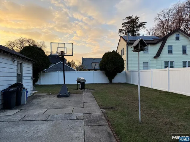 a backyard of a house with table and chairs
