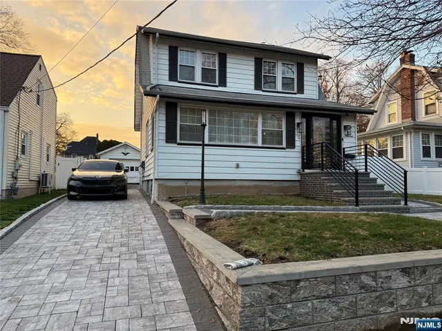 a view of a house with a car park side of a road