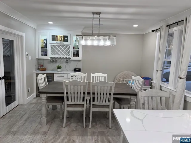 a dining room with furniture a chandelier and window