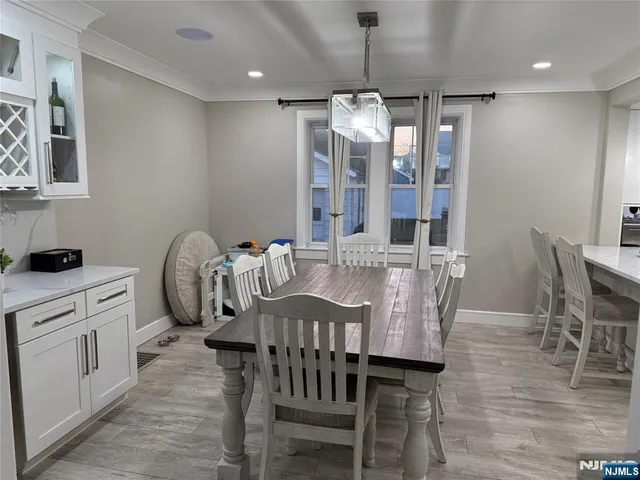 a view of a dining room with furniture wooden floor and chandelier